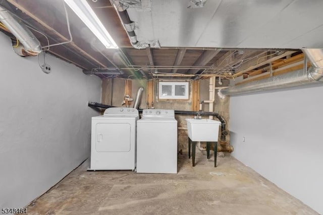 unfinished basement with a sink and washer and dryer
