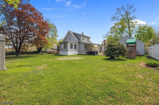 view of yard featuring fence and a playground