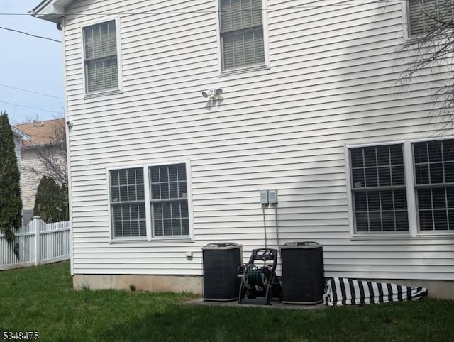 view of side of home with central air condition unit