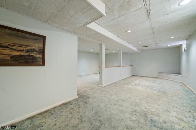 finished below grade area with baseboards, carpet floors, and recessed lighting