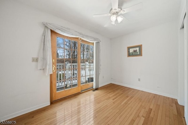 empty room with baseboards, light wood-style flooring, and a ceiling fan