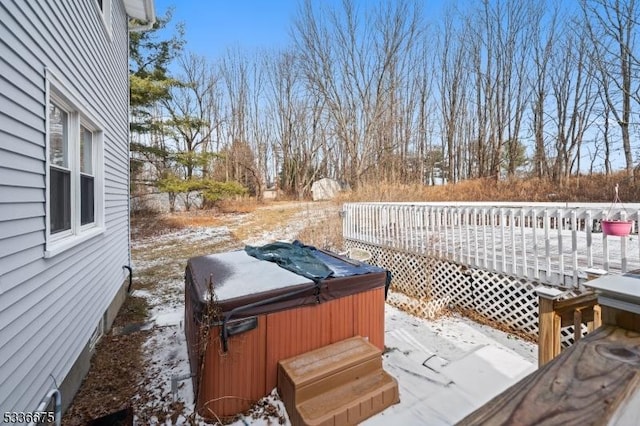 snow covered deck featuring a hot tub