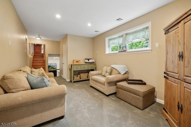 living room with light carpet, stairs, baseboards, and recessed lighting