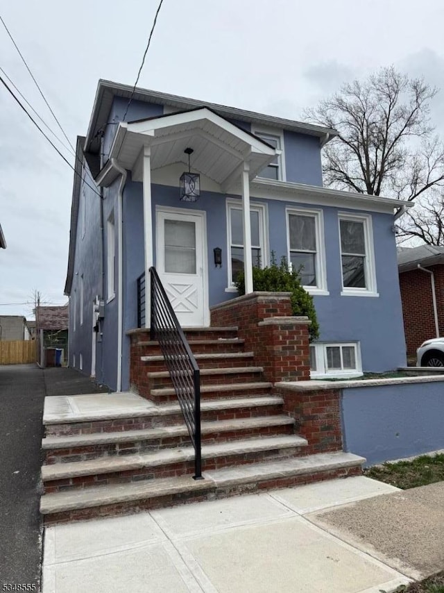 bungalow with stucco siding