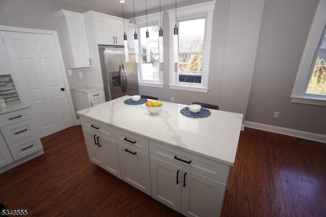 kitchen with stainless steel fridge, plenty of natural light, and dark wood finished floors
