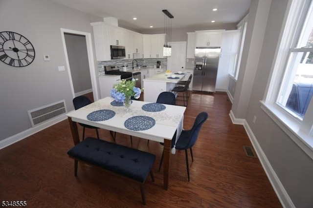 dining room featuring baseboards, dark wood finished floors, visible vents, and recessed lighting