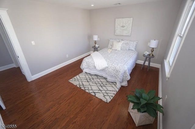bedroom featuring baseboards and wood finished floors