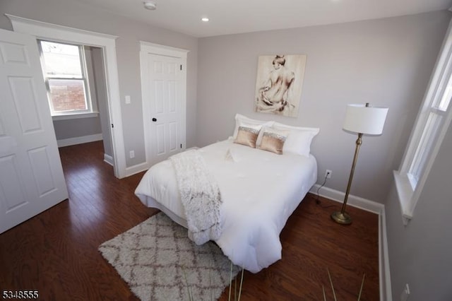 bedroom featuring recessed lighting, dark wood-style flooring, and baseboards