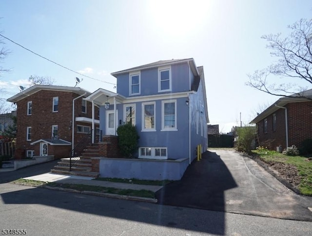 view of front of house featuring driveway and stucco siding