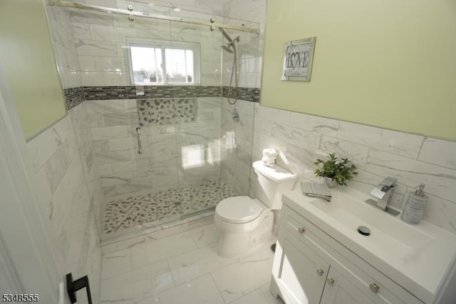 bathroom with a shower stall, vanity, marble finish floor, and toilet