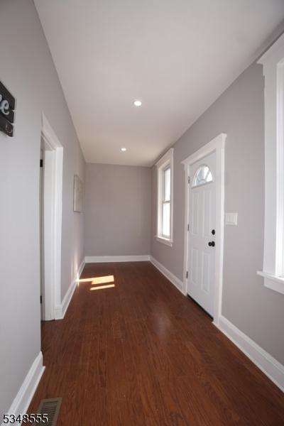 foyer featuring visible vents, baseboards, recessed lighting, and wood finished floors