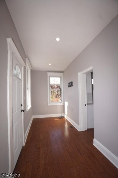 entryway featuring wood finished floors, baseboards, and recessed lighting