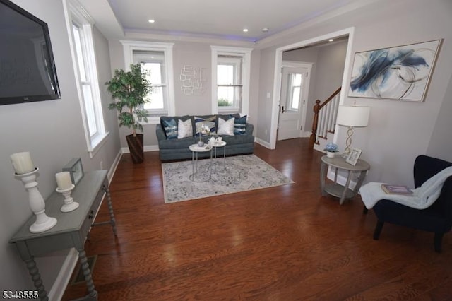 living area featuring dark wood-type flooring, baseboards, recessed lighting, and stairs