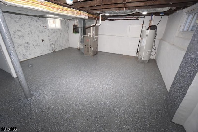 below grade area featuring heating unit and water heater