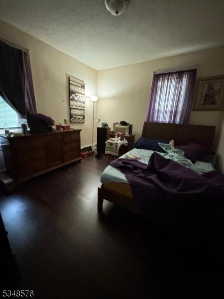 bedroom with dark wood-style floors