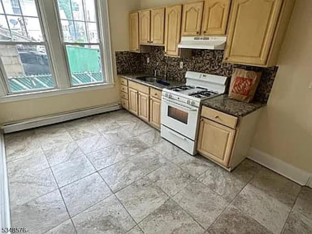 kitchen featuring a baseboard heating unit, white gas range oven, a sink, tasteful backsplash, and under cabinet range hood