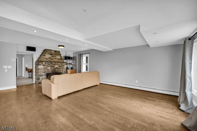 677 Warwick Tpke, West Milford Twp, NJ 07421 - unfurnished living room with a baseboard radiator, wood finished floors, a fireplace, recessed lighting, and baseboards