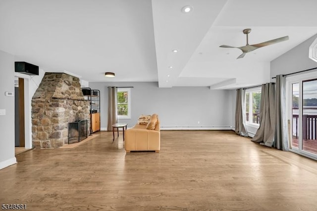 677 Warwick Tpke, West Milford Twp, NJ 07421 - living room with a fireplace, wood finished floors, a ceiling fan, recessed lighting, and a baseboard heating unit