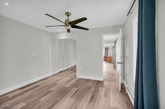 677 Warwick Tpke, West Milford Twp, NJ 07421 - unfurnished bedroom with light wood-style flooring, a baseboard radiator, baseboards, recessed lighting, and a closet
