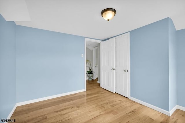 677 Warwick Tpke, West Milford Twp, NJ 07421 - unfurnished bedroom with light wood-type flooring, baseboards, and a closet