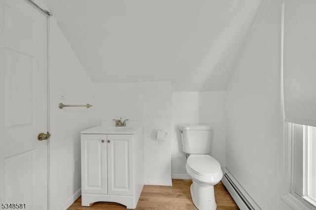 677 Warwick Tpke, West Milford Twp, NJ 07421 - bathroom featuring vaulted ceiling, toilet, vanity, wood finished floors, and baseboards