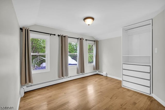 677 Warwick Tpke, West Milford Twp, NJ 07421 - unfurnished bedroom with baseboard heating, lofted ceiling, wood finished floors, and baseboards