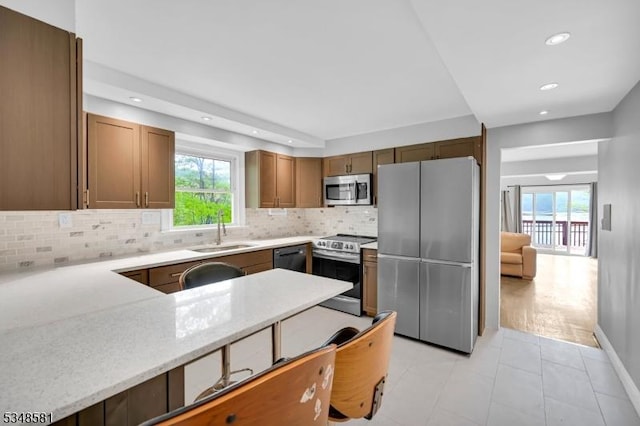 677 Warwick Tpke, West Milford Twp, NJ 07421 - kitchen featuring stainless steel appliances, a sink, healthy amount of natural light, decorative backsplash, and recessed lighting