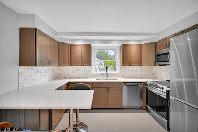 677 Warwick Tpke, West Milford Twp, NJ 07421 - kitchen with stainless steel appliances, a sink, brown cabinets, light countertops, and tasteful backsplash