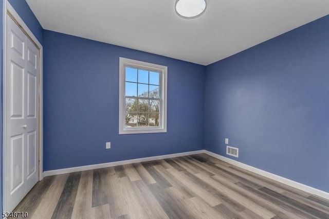 63 S Lincoln Ave, Washington Boro, NJ 07882 - unfurnished bedroom with wood finished floors, baseboards, a closet, and visible vents