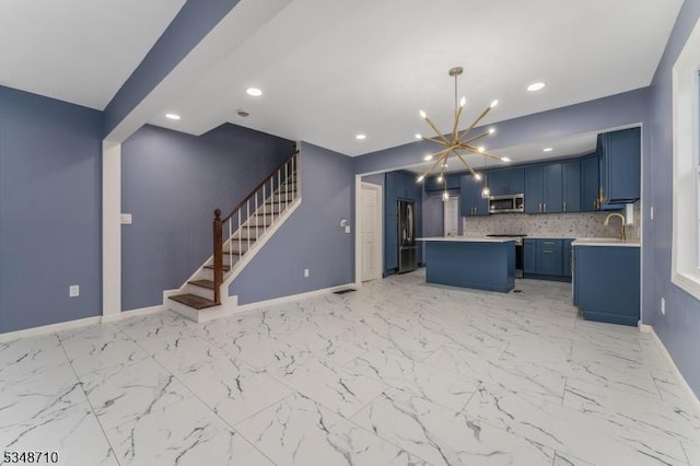 63 S Lincoln Ave, Washington Boro, NJ 07882 - kitchen with a kitchen island, a chandelier, appliances with stainless steel finishes, blue cabinets, and light countertops