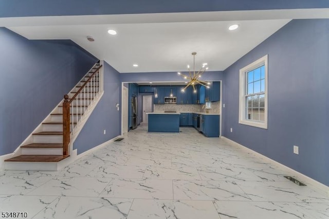 63 S Lincoln Ave, Washington Boro, NJ 07882 - kitchen featuring an inviting chandelier, light countertops, blue cabinetry, stainless steel appliances, and marble finish floor