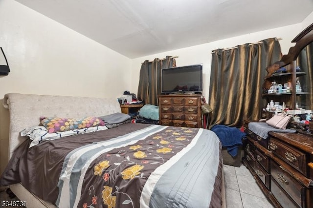 bedroom with light tile patterned flooring