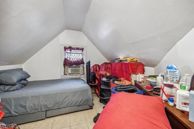 bedroom with tile patterned flooring, cooling unit, and lofted ceiling