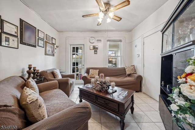 living room featuring light tile patterned floors and ceiling fan