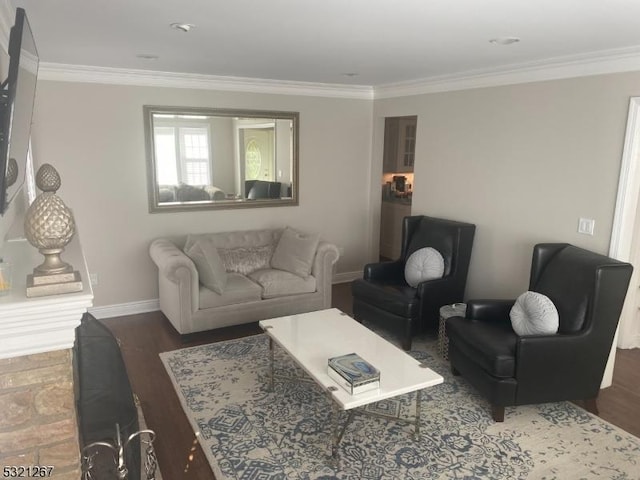 living area featuring wood finished floors, baseboards, and ornamental molding