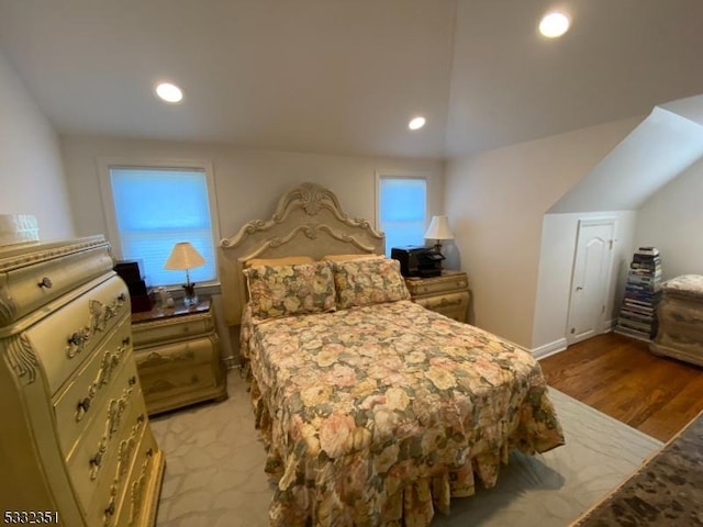 bedroom featuring light wood finished floors, vaulted ceiling, and recessed lighting