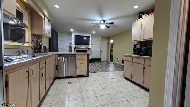 kitchen featuring open floor plan, ceiling fan, appliances with stainless steel finishes, a peninsula, and decorative backsplash
