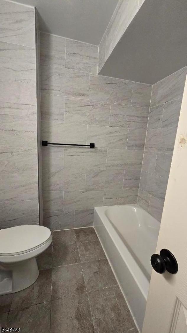 full bathroom with toilet, a bath, and a shower