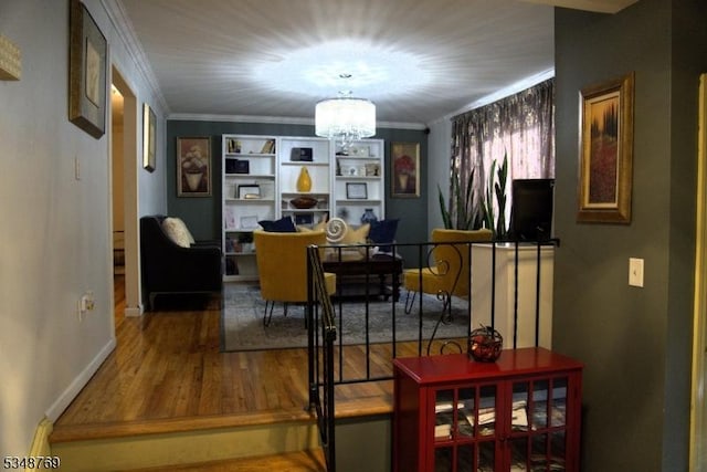 dining room with crown molding, baseboards, an inviting chandelier, and wood finished floors