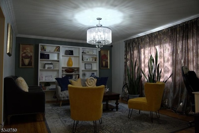 sitting room featuring a chandelier, wood finished floors, and ornamental molding