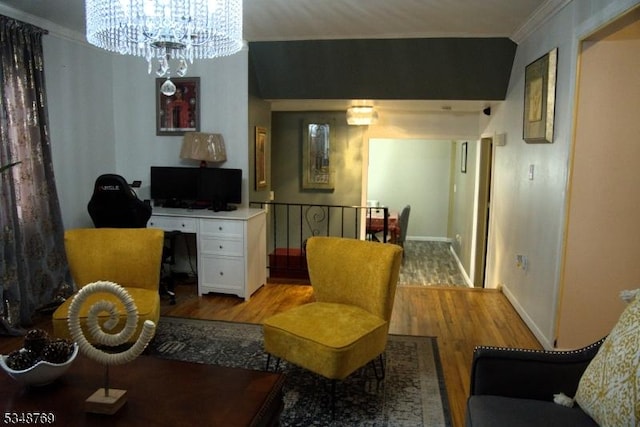 sitting room featuring crown molding, baseboards, light wood-type flooring, and an inviting chandelier