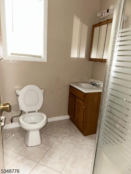 237 Warren St, Paterson City, NJ 07524 - full bathroom with vanity, a shower stall, and tile patterned floors