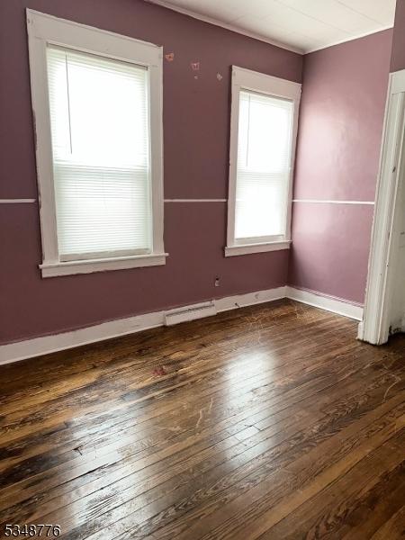 237 Warren St, Paterson City, NJ 07524 - empty room featuring healthy amount of natural light and dark wood finished floors
