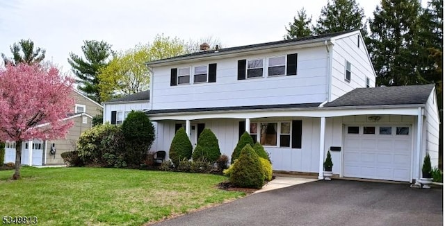 29 King Rd, Franklin Twp, NJ 08873 - traditional-style home featuring a chimney, a front lawn, aphalt driveway, board and batten siding, and an attached garage