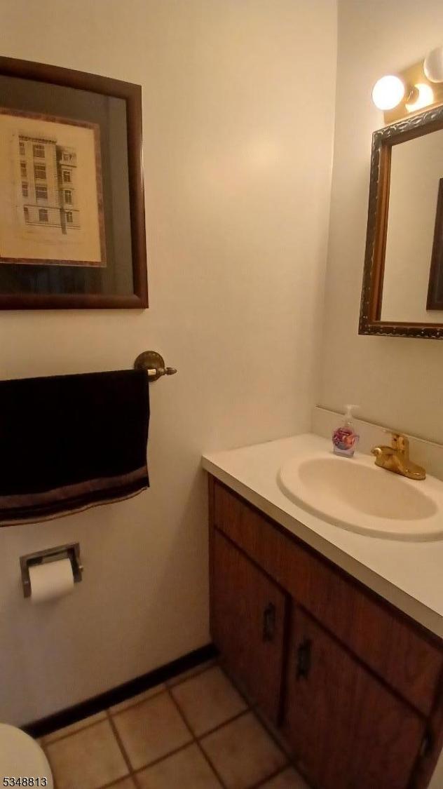 29 King Rd, Franklin Twp, NJ 08873 - half bath with tile patterned flooring, vanity, and toilet