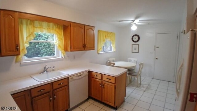 29 King Rd, Franklin Twp, NJ 08873 - kitchen featuring a sink, white appliances, light tile patterned floors, light countertops, and a peninsula