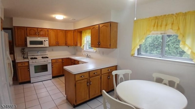 29 King Rd, Franklin Twp, NJ 08873 - kitchen with light countertops, a sink, white appliances, a peninsula, and brown cabinetry