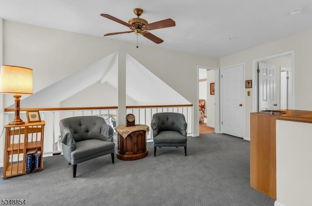 living area with carpet floors, a ceiling fan, and lofted ceiling with beams