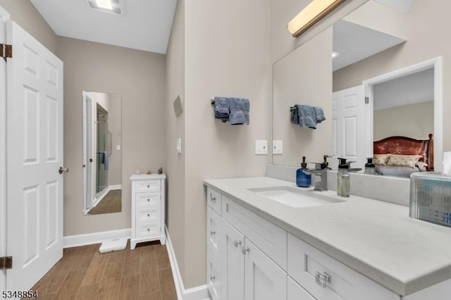 full bathroom featuring wood finished floors, visible vents, vanity, and baseboards