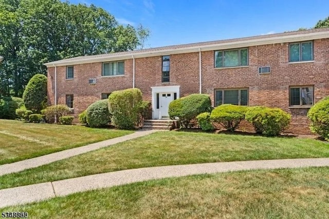 view of front of house featuring a front yard and brick siding